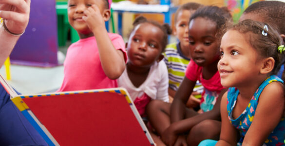 Group of primary aged schoolchildren listening to a story