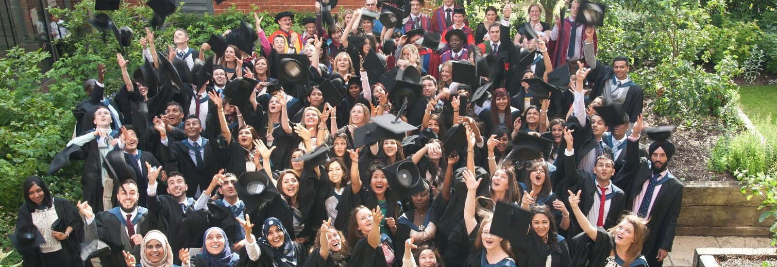 Graduates throwing mortarboards