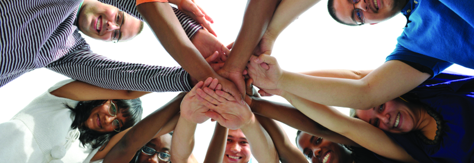 Multiple hands together in a huddle