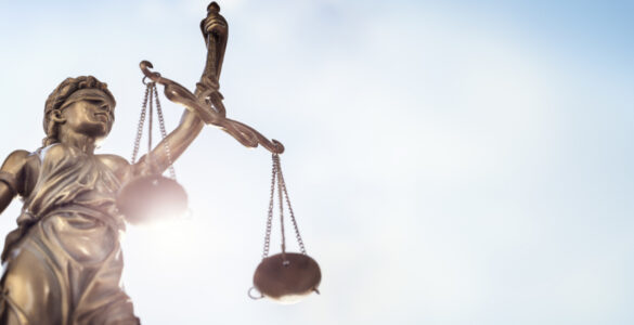 Legal law concept statue of Lady Justice with scales of justice sky background