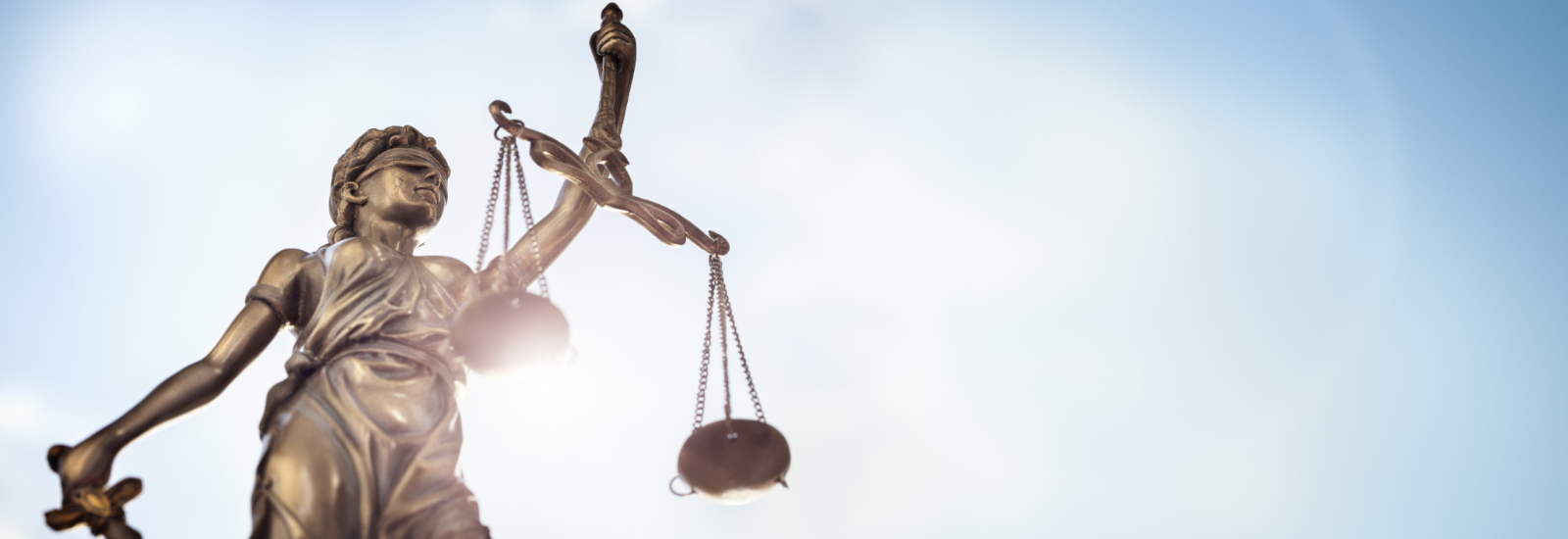Legal law concept statue of Lady Justice with scales of justice sky background