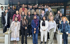 Students who are taking part in the Telephone Campaign, standing on the steps of the Carrington Building