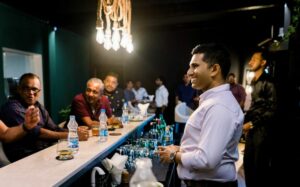 Sushan greeting guests at a bar