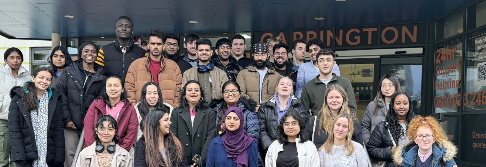 Group of students who participated in the telephone campaign, standing on steps on Whiteknights Campus