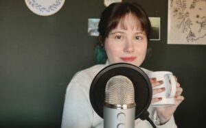 Nichola sat in front of a microphone