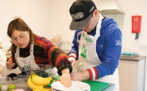 Two people cooking at the Maymessy cooking school