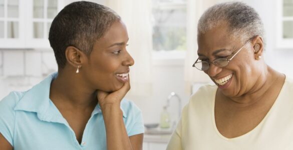 A daughter looking at her mother who is smiling