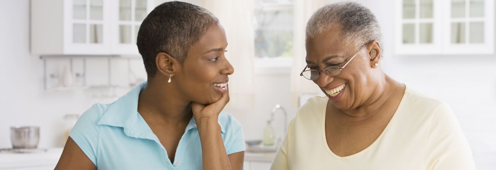 A daughter looking at her mother who is smiling