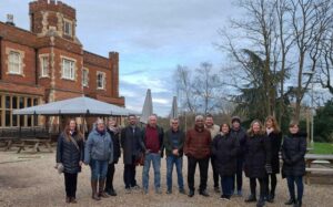 The group on their 25th anniversary reunion standing in front of Park House on Whiteknights Campus.