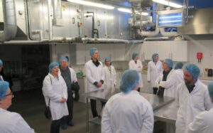 The group on a tour of the Food Building in 2024