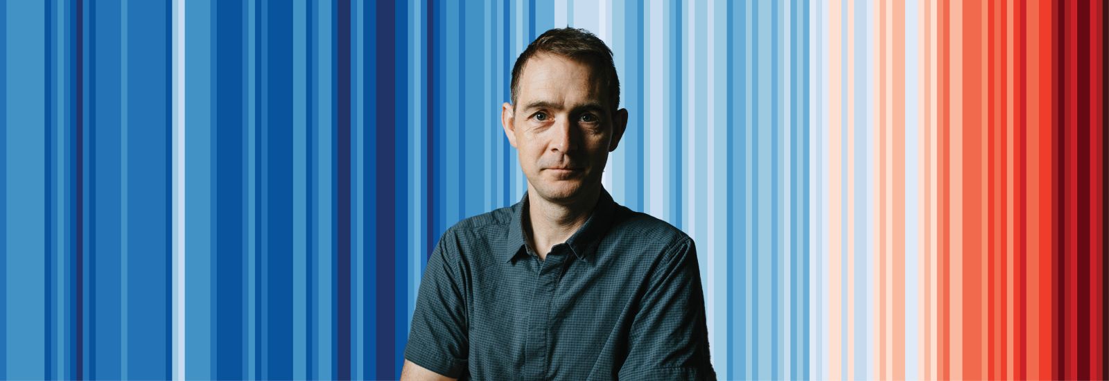 Ed Hawkins in front of the climate stripes