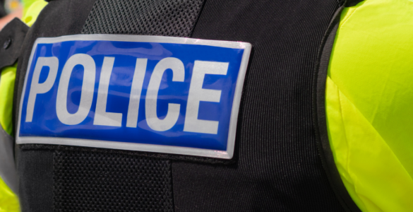 Police badge on the back of a police uniform