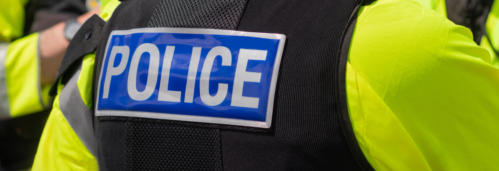 Police badge on the back of a police uniform
