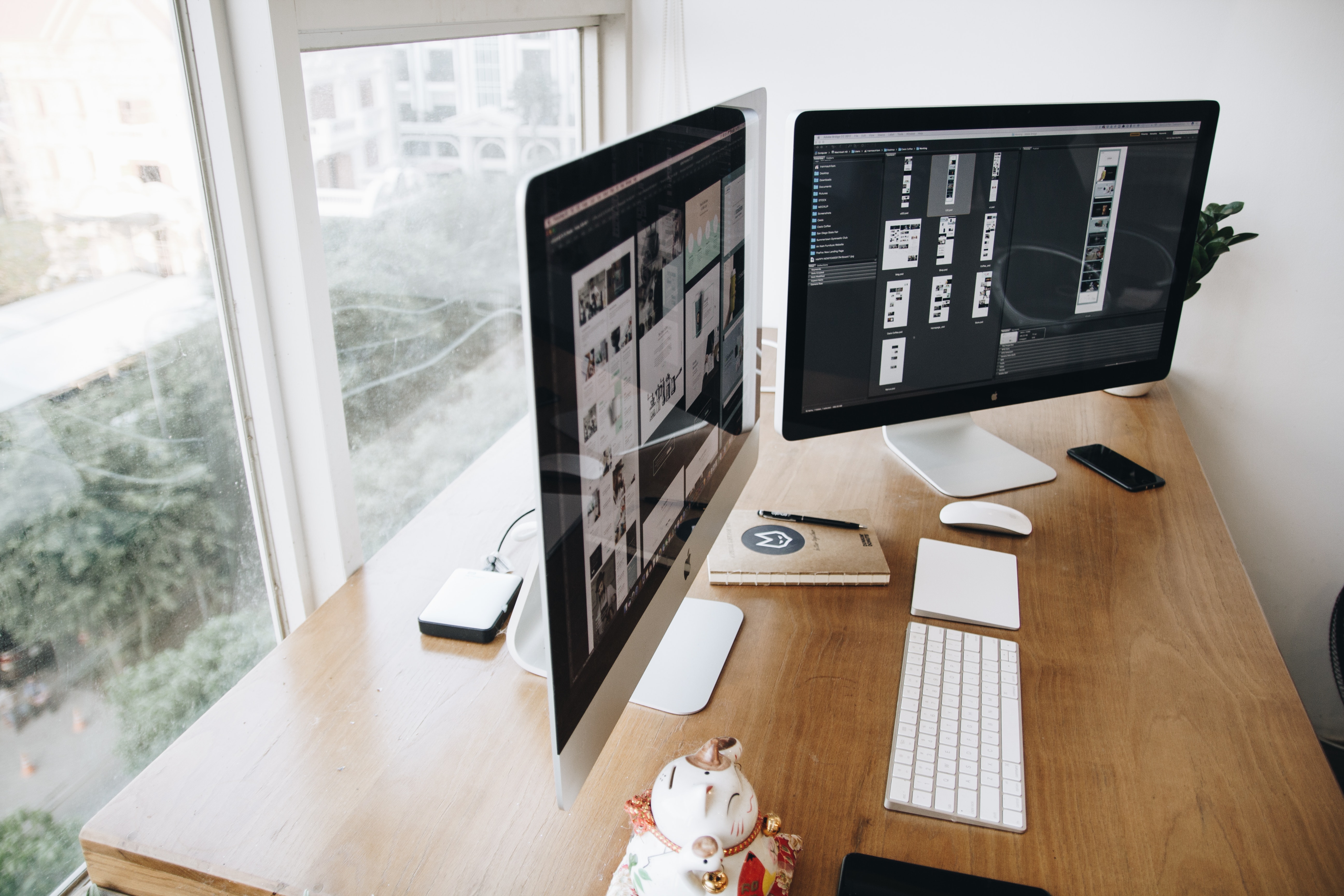 Dual computer screens side by side on a desk.