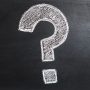 A question mark drawn on a chalkboard.