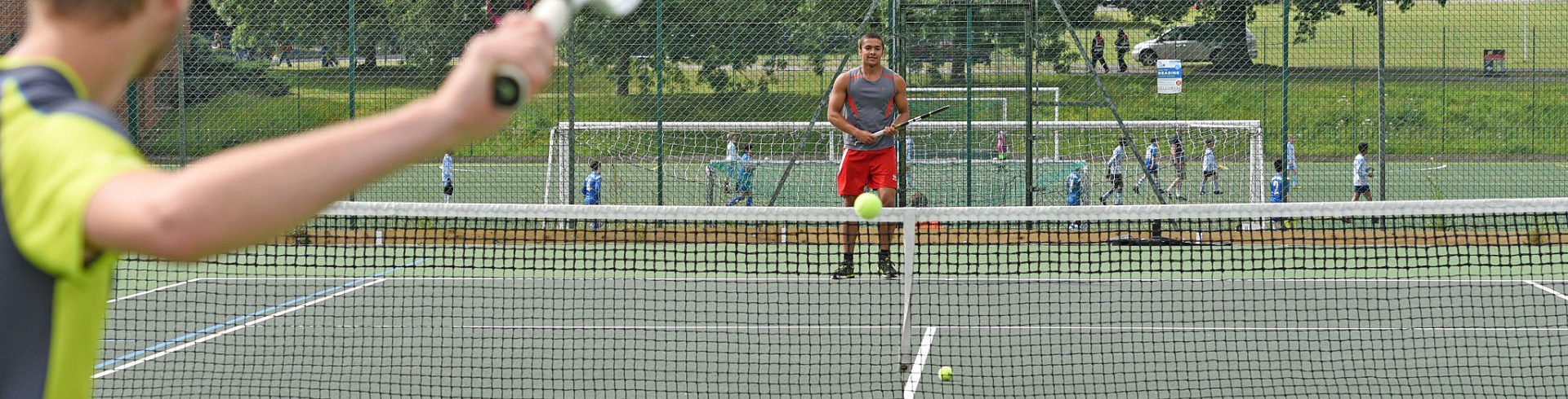 A photo of two people playing tennis at University of Reading Whiteknights campus